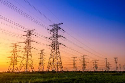 High voltage electricity tower for power supply, sky sunset landscape, industrial background.